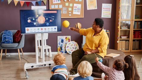 Confident mature teacher making presentation of solar system